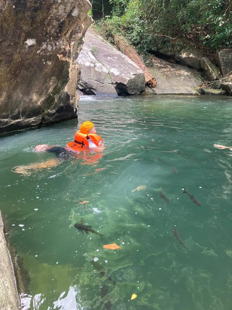 Harris family swim in waterfall